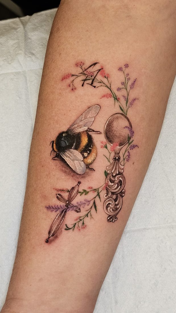 Bumblebee, ornate silver spoon and lavender sprigs, colour tattoo on a forearm